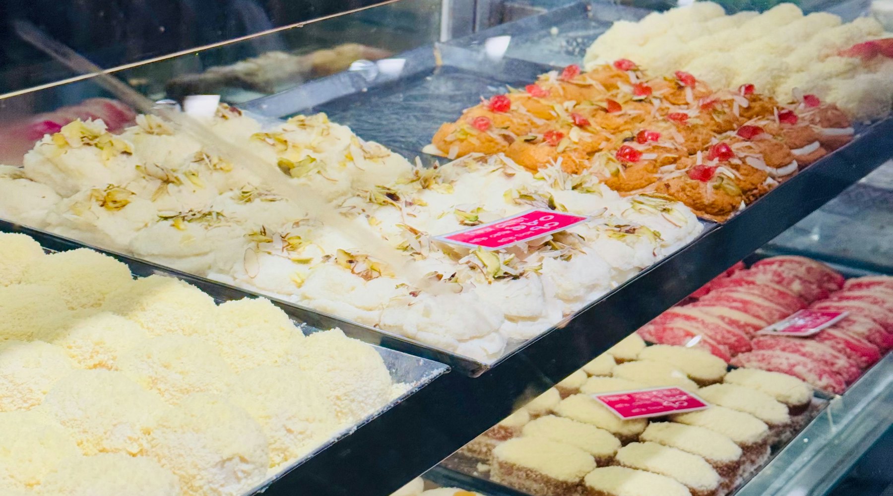 An assortment of Indian confectionery displayed in a sweet shop